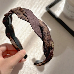 French vintage leopard print twisted headband with elegant gold metal accent for women