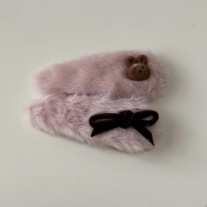 Detail of pink plush hair clips with cute brown felt rabbit and velvet bow decoration