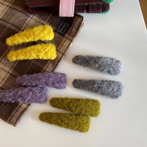 Set of 8 colorful plush hair clips for women in yellow, purple, grey, and green colors