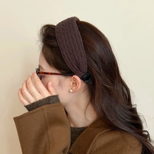 Deep brown knitted wide headband for women featuring a thick vertical ribbed texture