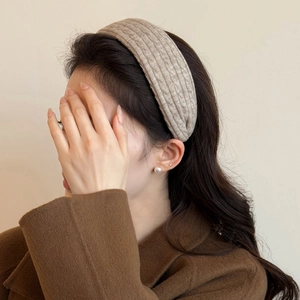 Close-up of knit headband with chunky cable texture and warm autumn aesthetic