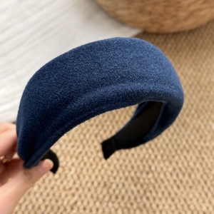 Detailed close-up of dark blue padded sponge headband with premium wool-like textured fabric