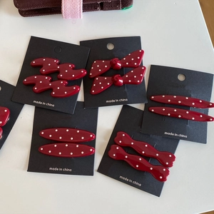 Red and white polka dot hair clip set with multiple shapes on display cards