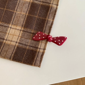 Sweet vintage red polka dot bow hair clip for Christmas styled on classic checkered fabric