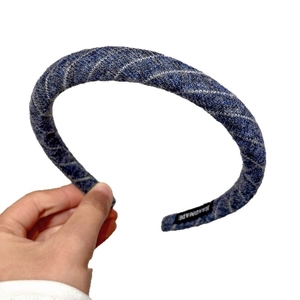 Blue denim textured headband with silver diagonal stripes and handmade woven label