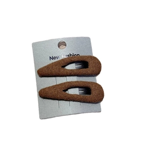 Set of two dark brown knitted fabric BB hair clips on a grey display card for women