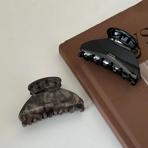 Elegant French handmade acetate hair claws in glossy black and grey marble finish