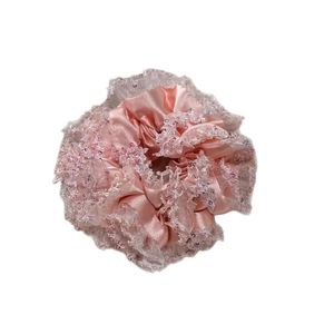 Pink satin scrunchie with white lace edges and colorful sequins for hair styling