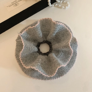 Gray rabbit fur knitted scrunchie with pink wavy edges and soft plush texture