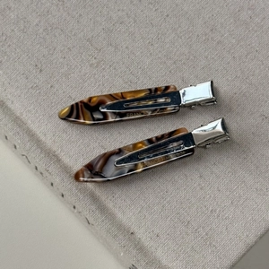 Macro detail of tortoiseshell acetate hair clips with France Handmade silver metal base