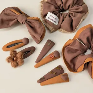 Detail view of vintage brown and yellow hair accessories set with handmade bows and clips
