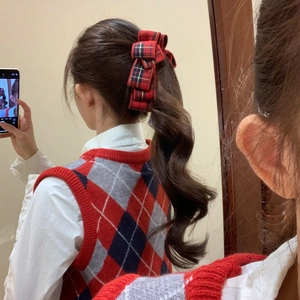 Elegant red plaid bow banana clip for women shown in a classic ponytail hairstyle
