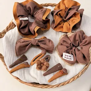 Handmade autumn hair accessories set with scrunchies and bow clips in caramel tones