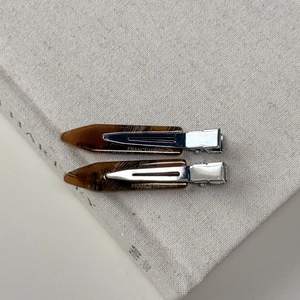 Detail showing amber textured hair clips with France Handmade gold lettering