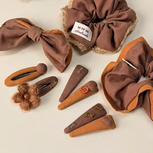 Brown and yellow autumn hair accessory set including scrunchies and bow clips