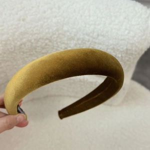 Macro shot of plush mustard yellow velvet headband with padded wide brim for volume