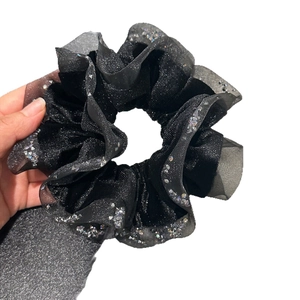 Elegant black velvet scrunchie with sparkling holographic sequins for high-end hair styling