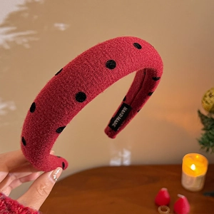 Close-up of red tweed headband with black polka dots and handmade fabric label detail