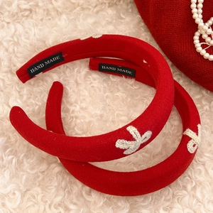 Set of two red padded sponge headbands with handmade white woven bow decorations