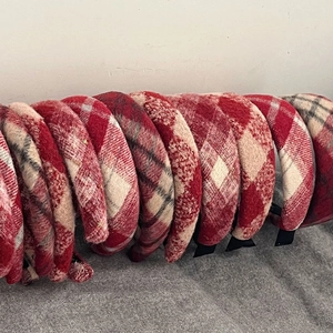 Detailed view of red and white plaid flannel headbands with thick autumn texture