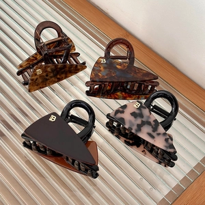 Set of four leopard print acetate triangle hair claws with gold B letter accents