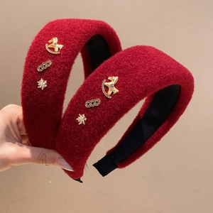 Red wool padded headband with festive gold horse charms and coins for a high crown look