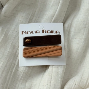 Macro detail of vintage acetate hair clips with marble texture on a white linen surface