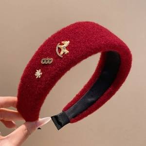 Red plush padded headband with gold star and snowflake charms for festive styling