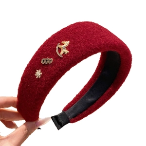 Deep red plush headband with golden rocking horse charm and snowflake ornaments