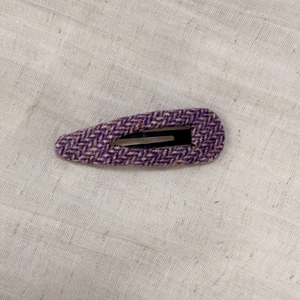 Detail of purple tweed fabric BB hair clip with vintage V-shaped woven texture