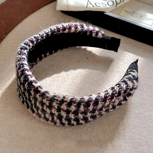 Close-up detail of luxury French style tweed headband with black and white woven pattern