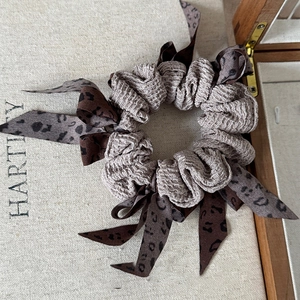 Detail of Korean bubble fabric hair scrunchie with leopard print ribbon bow decoration