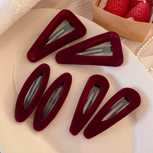 Vintage red velvet hair clip set with 6 pieces of drop and triangle shapes in warm lighting
