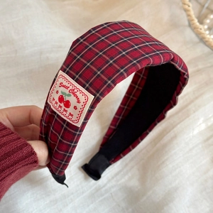 Close-up of red plaid headband featuring sweet cherry embroidery and non-slip inner lining