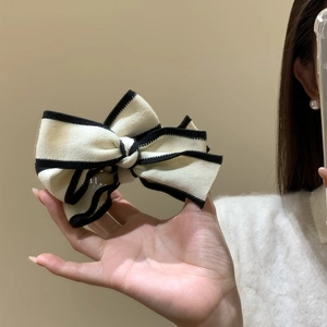 Elegant knit bow banana hair clip with black and white contrast trim for women
