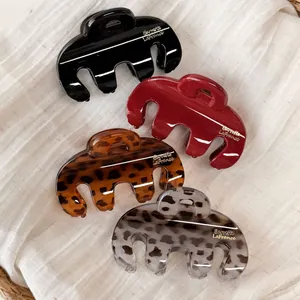 Set of four glossy rectangular hair claw clips in black, red, and leopard print colors
