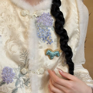 Detailed close-up of embroidered Song brocade vest with faux fur trim and horse brooch