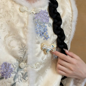 Detail of handmade Song Brocade horse brooch on ivory silk vest with floral embroidery