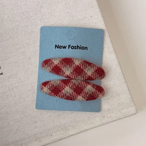 Detail view of red argyle wool fabric BB hair clips for women on New Fashion card