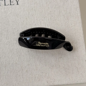 Minimalist glossy black resin banana hair clip with elegant gold Barrette La France text