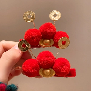 Cute red Chinese New Year hair clips with gold sycee and festive plush balls