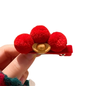 Chinese New Year red hair clip featuring three plush balls and a golden ingot decoration