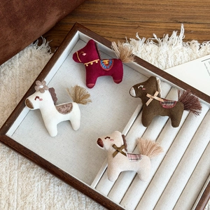 Set of four handmade embroidered pony brooches in red, white, brown, and beige plush fabric