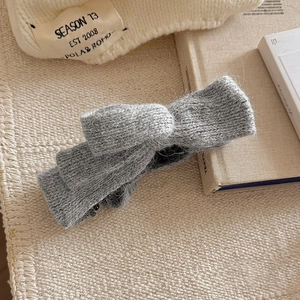 Grey knitted bow banana hair clip with soft plush texture for winter high ponytail styles