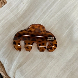 Detail view of large tortoiseshell shark clip with gold Barrette LaFrance lettering