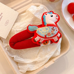 Detailed embroidery of festive red horse hair clip with floral patterns and Fu character