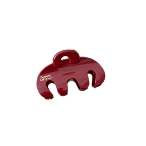 Glossy burgundy hair claw clip with French lettering in a large shark jaw style