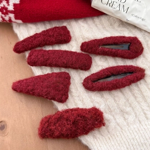 Set of 6 plush red heart hair clips with soft fleece texture on knit background