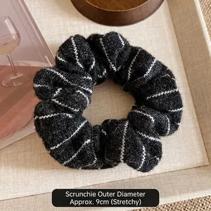 Macro detail of high-elasticity black and white striped knitted hair scrunchie 9cm diameter