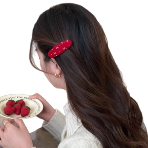 Elegant red velvet hair clip with embroidered bow and polka dots for festive hairstyles